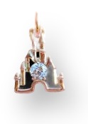 A small gold castle-shaped charm set with a round diamond, displayed hanging inside an open pink Pandora jewelry gift box, held in someone's hand.