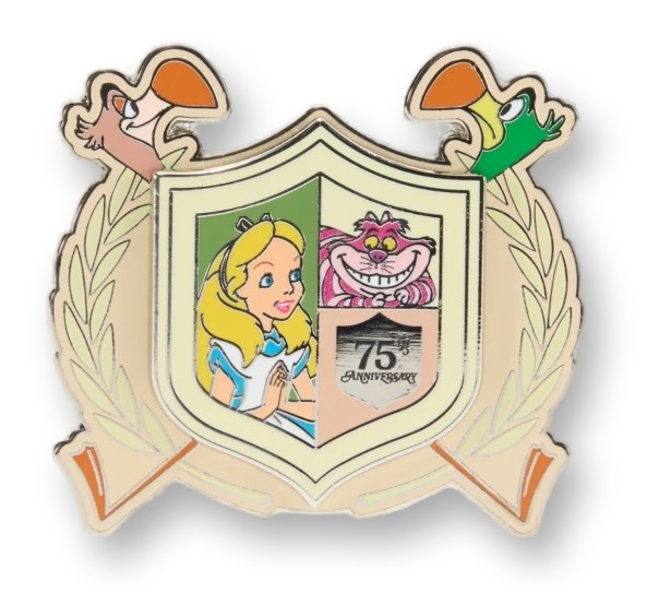Cream and gold crest-shaped enamel pin with two flamingo heads at the top, framing a shield split between an illustration of Alice and the grinning pink Cheshire Cat over a '75th Anniversary' banner.