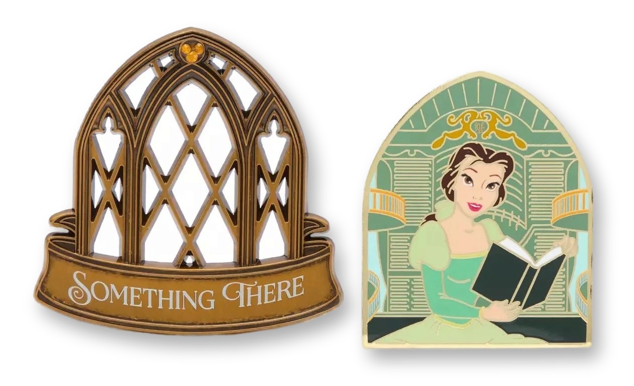 Two enamel pins side by side: a gothic gold castle-window magnetic topper reading 'Something There', and the arched base pin beneath it showing Belle reading a book in the West Wing.