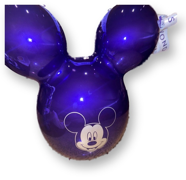 Purple Mickey Mouse balloon-shaped Disney100 popcorn bucket with a printed Mickey face